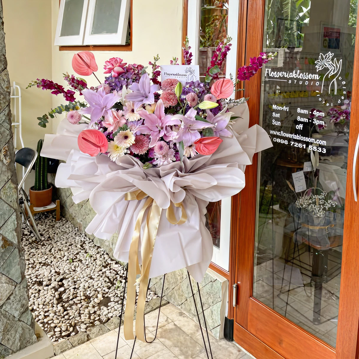Florist carefully arranging fresh flowers at Floweriablossom atelier in Malang